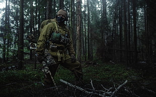 man holding hunting rifle near rainforest HD wallpaper